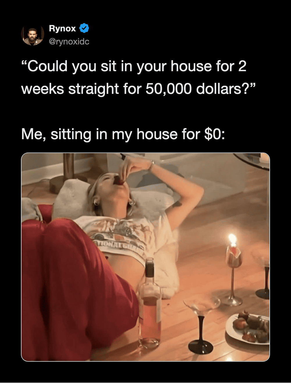Woman drinking from a bottle while sitting on a couch with a candle and drinks on a table.