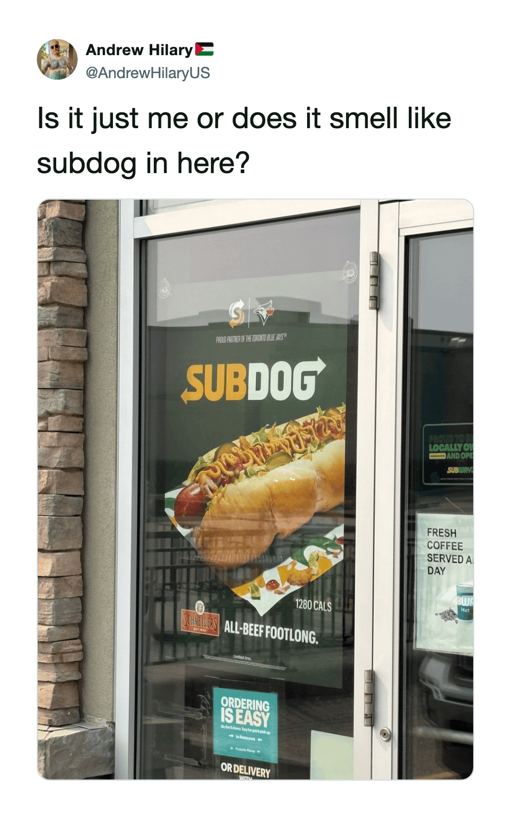 Subway door with a large Subway sandwich image on the glass.