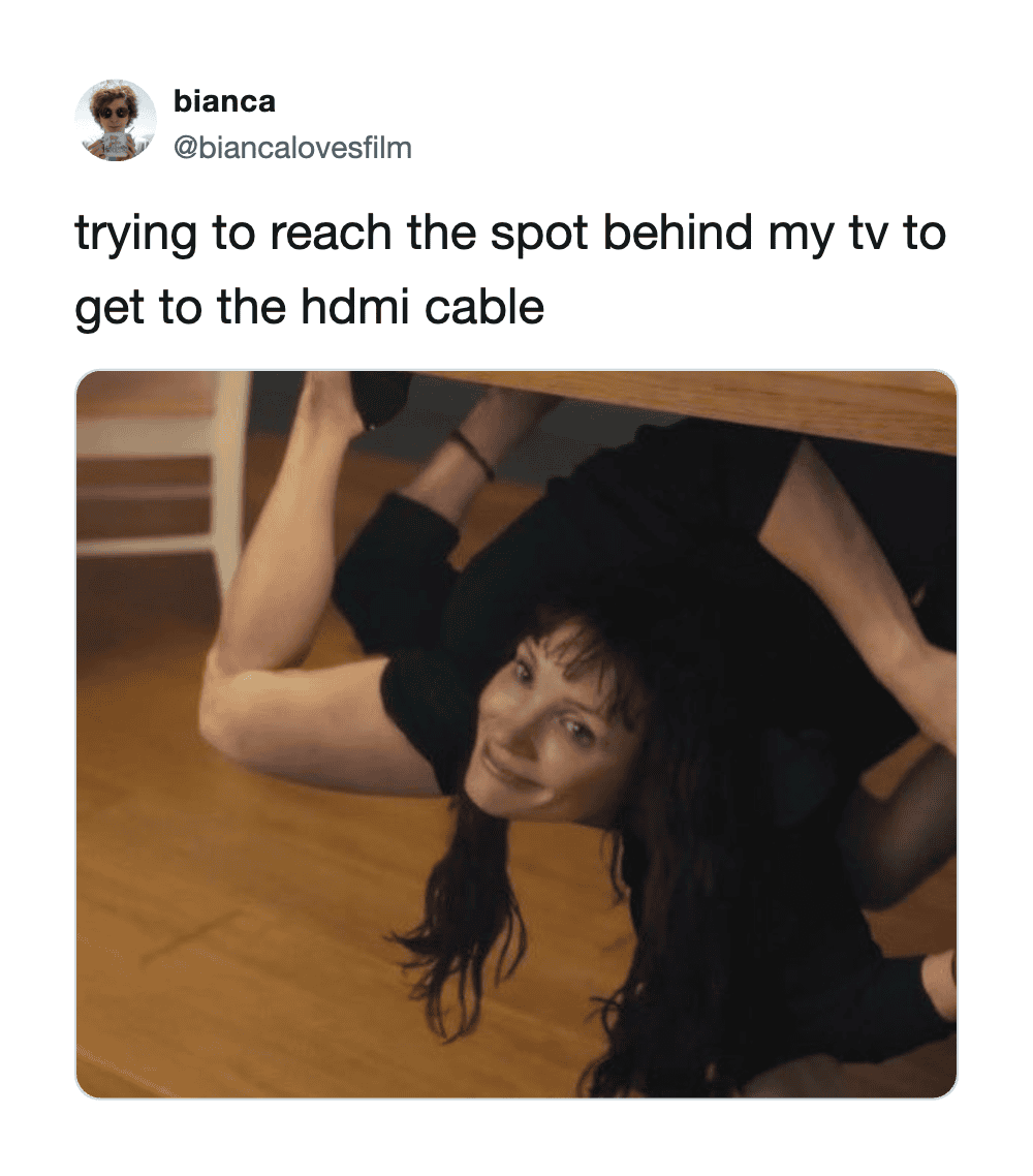 Trying to reach the spot behind my TV to get to the HDMI cable.