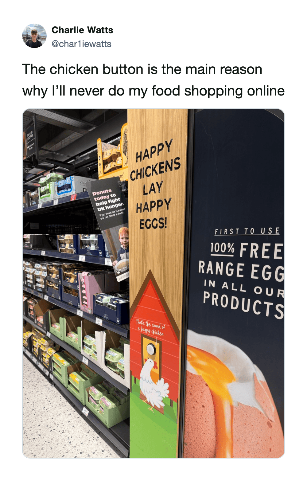 Shelf with eggs and a sign saying 'Happy Chickens Lay Happy Eggs' in a store.