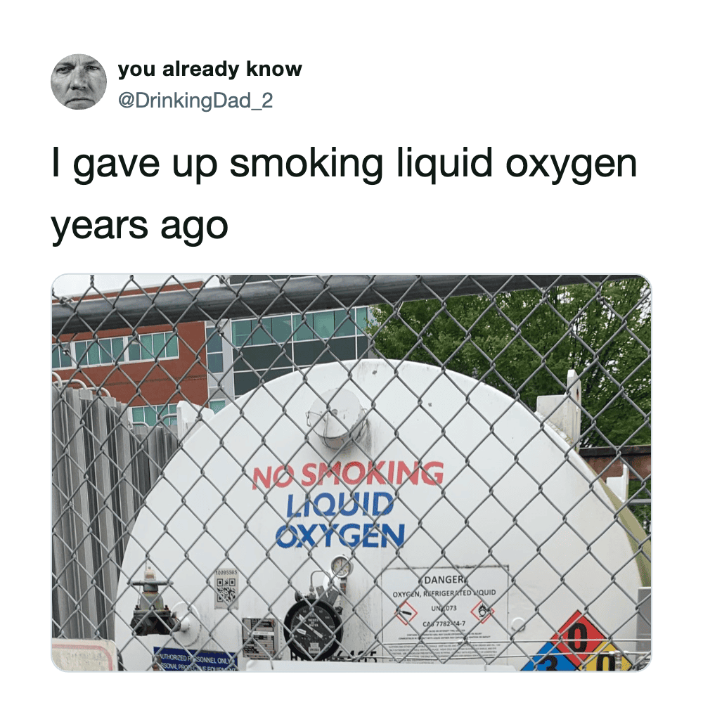 Tank labeled 'Liquid Oxygen' with 'No Smoking' sign behind a chain-link fence.
