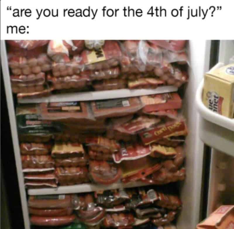 Image of a freezer filled with various meats and hot dogs.