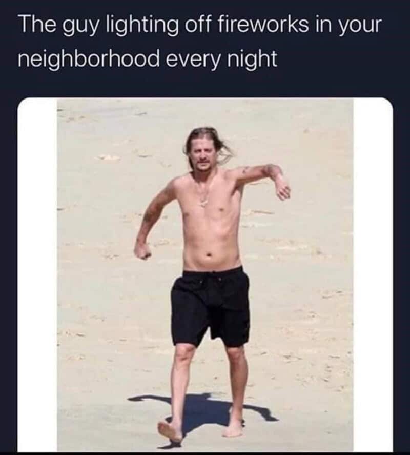 Man on beach lighting fireworks at night, meme about neighborhood fireworks.