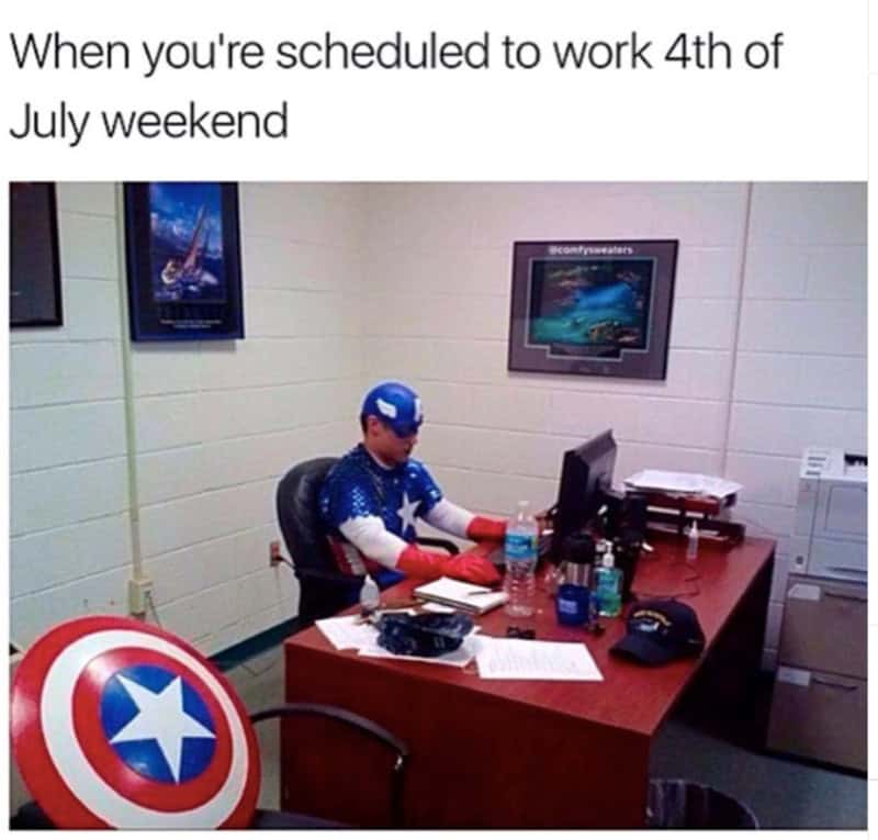 Person in patriotic costume working at desk with Captain America shield.