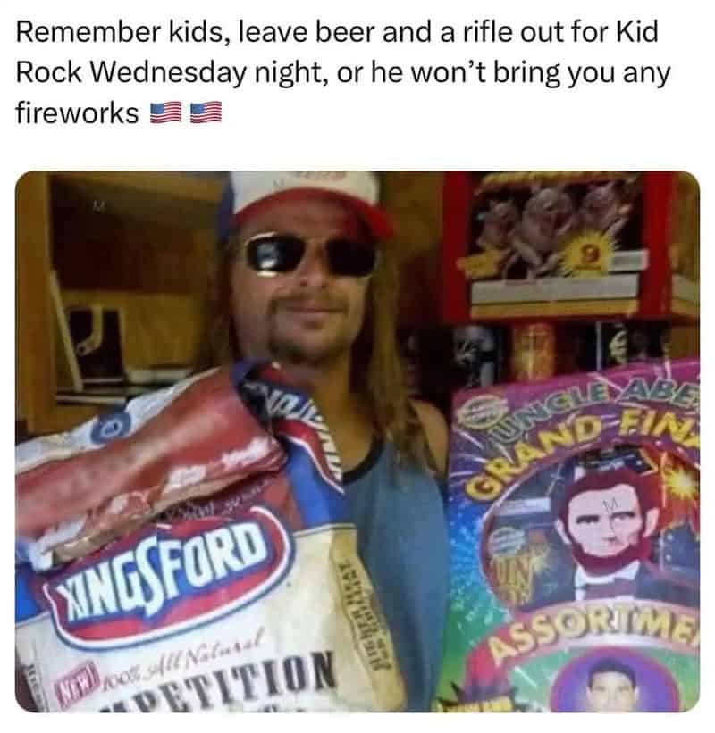 Man with sunglasses holding Kingsford charcoal bag, fireworks in background.