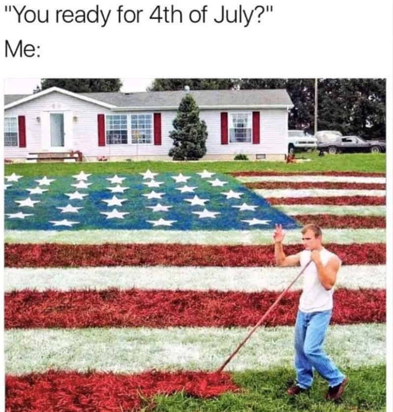 Boy raking American flag design on lawn with house in background.