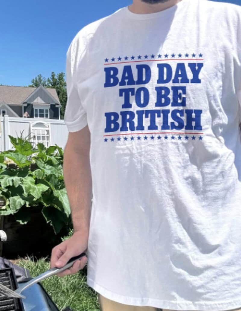 T-shirt with text 'BAD DAY TO BE BRITISH' in blue letters.