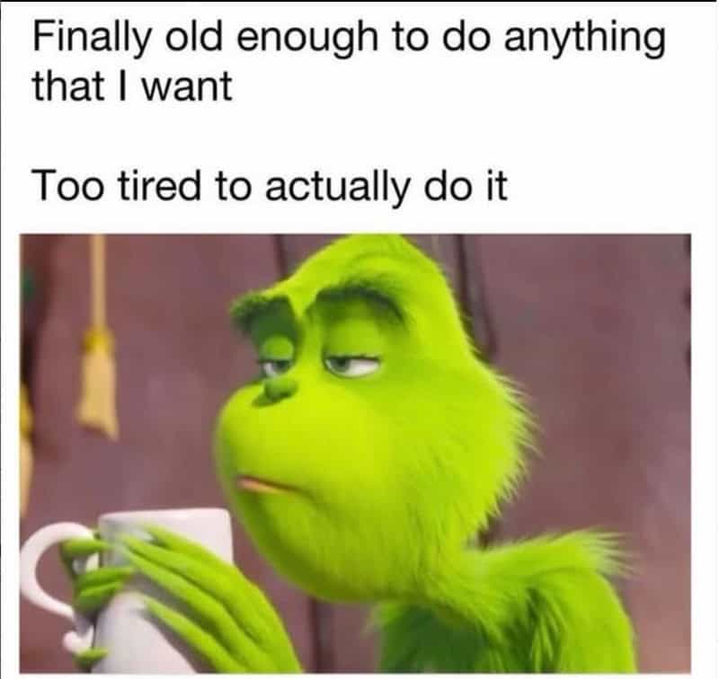Grumpy green creature with a tired expression holding a mug, with text about being too old and tired.