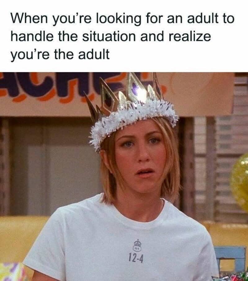 Woman wearing a crown with a surprised expression, caption about adulting.