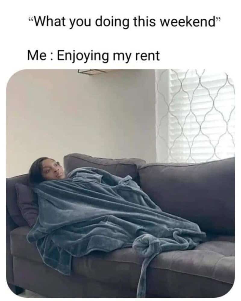 Person lying on a couch wrapped in a blanket, relaxing at home.