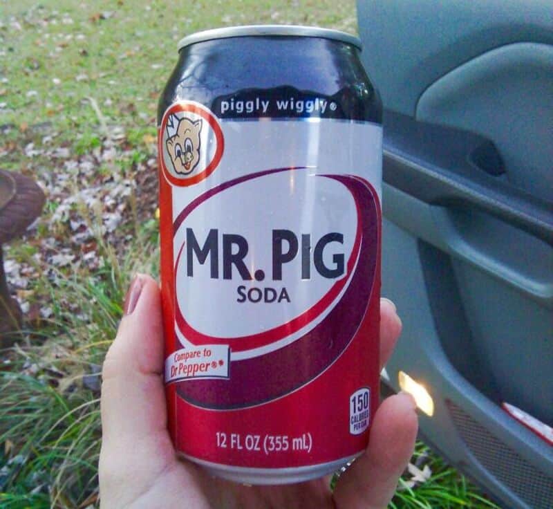 Can of Mr. Pig soda with a pig cartoon and 'Compare to Dr. Pepper' label.