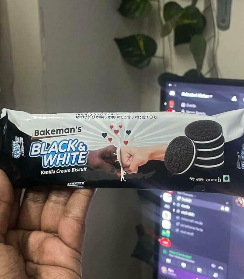 Bakeman's Black & White Vanilla Cream Biscuit package with two hands reaching for each other.