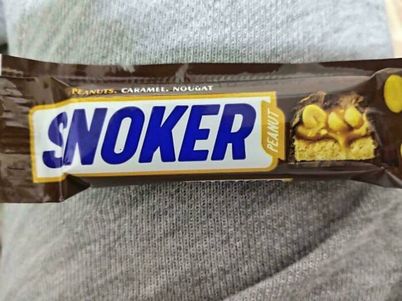Snoker peanut caramel nougat bar with yellow peanuts on packaging.