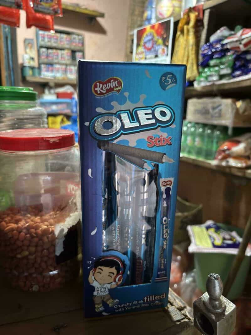 Oleo Stix crayon with a funny face on the packaging in a store.