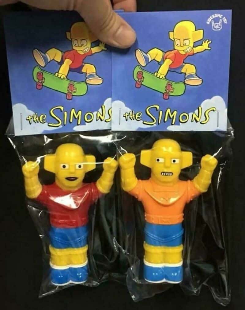 Two Simpsons toy figures in packaging with a Simpsons logo and cartoon image.