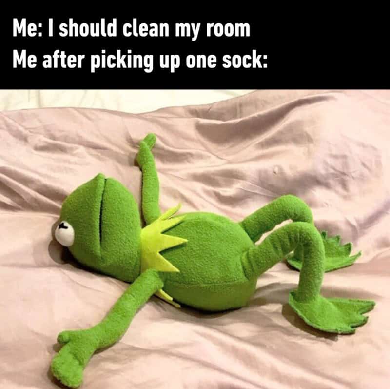 Green plush toy lizard lying on bed with text about cleaning a room after picking up a sock.