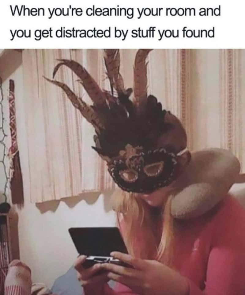 Person with a mask and horns looking at a phone, caption about cleaning distractions.