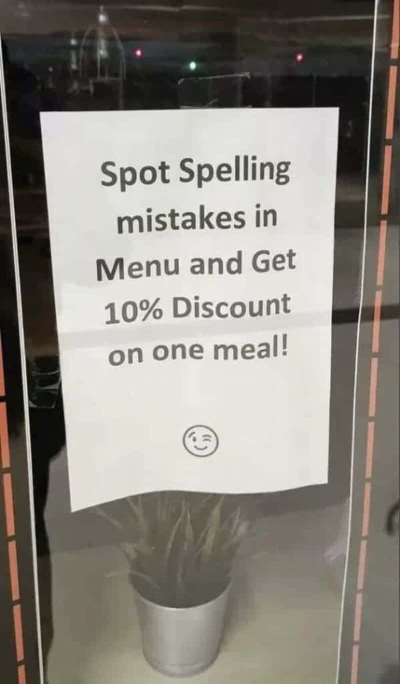 Sign about spot spelling mistakes in menu and discount offer with a smiley face.