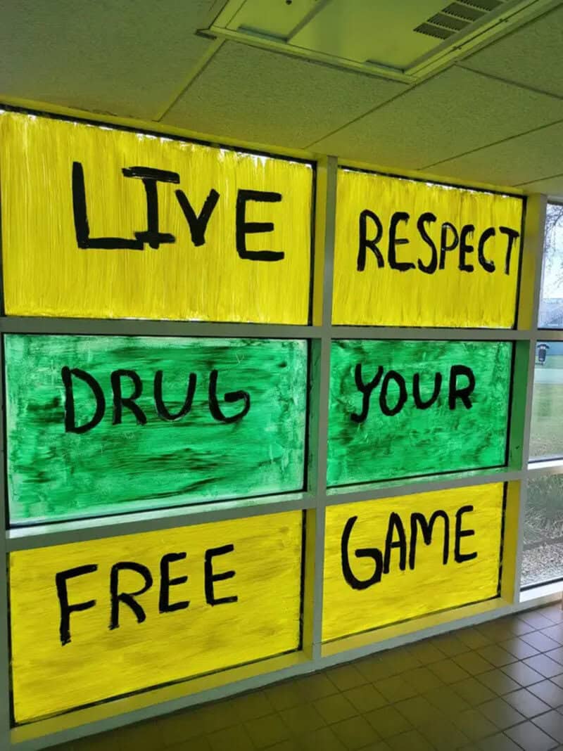 Live Respect, Drug Your Free Game painted on yellow and green panels.