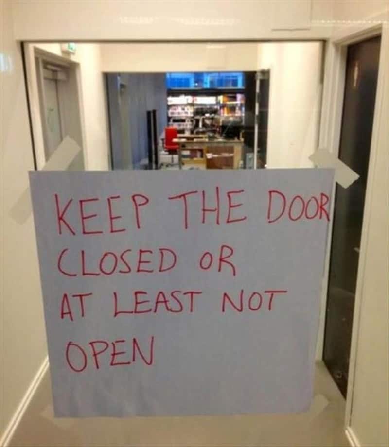 Sign says 'KEEP THE DOOR CLOSED OR AT LEAST NOT OPEN' in red marker.