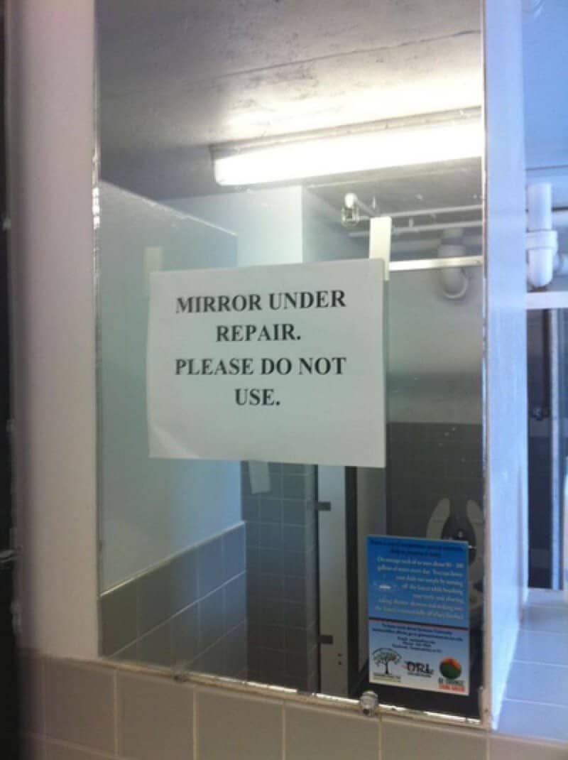 Mirror under repair, do not use sign in a bathroom or restroom.