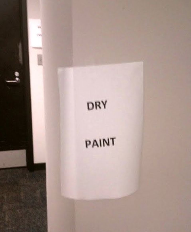 Dry paint sign on wall with the words 'DRY PAINT'.