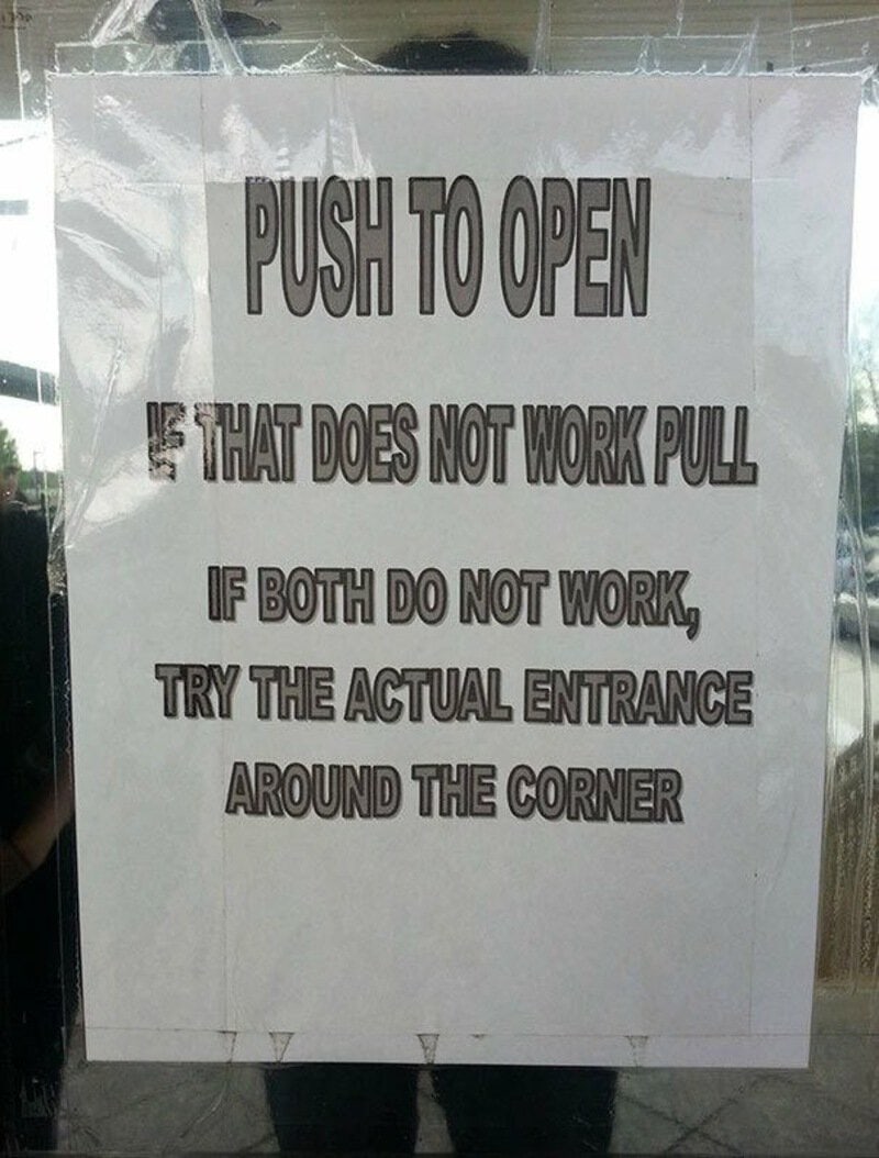 Push to open sign with confusing instructions about door operation.