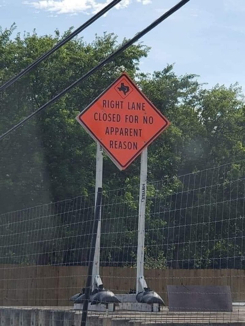 Road sign says 'Right lane closed for no apparent reason' with a humorous tone.