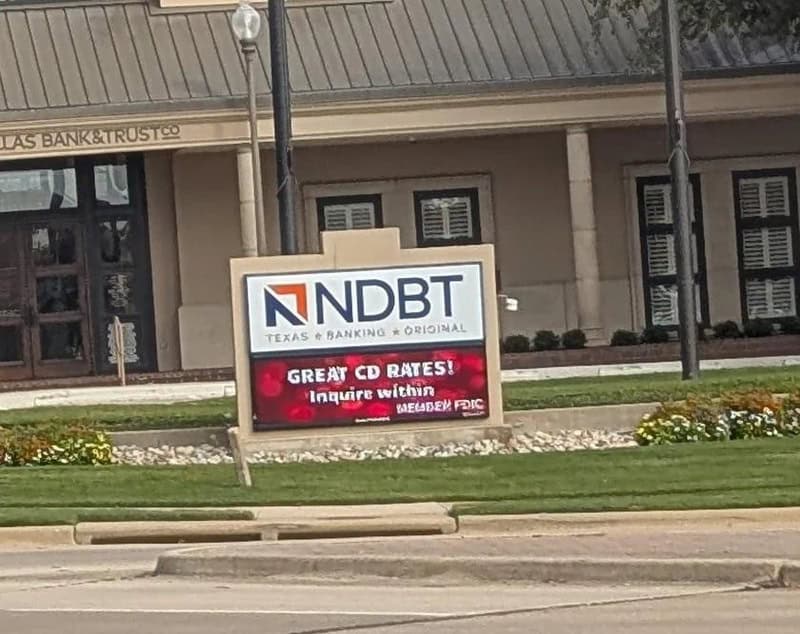 Sign for NDBT Texas & Banking with a red ad for great CD rates.
