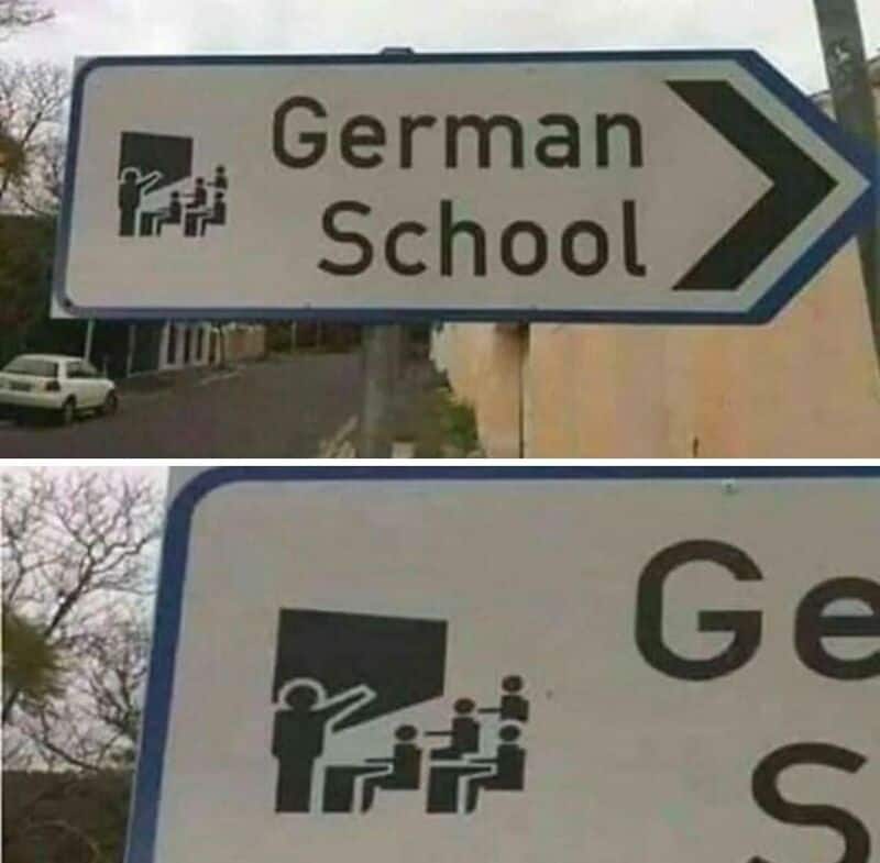 Sign for German School with a humorous illustration of a teacher and students.