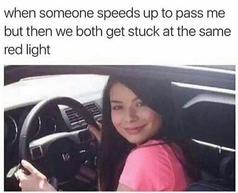 Young woman smiling in car with text about being stuck at red light.