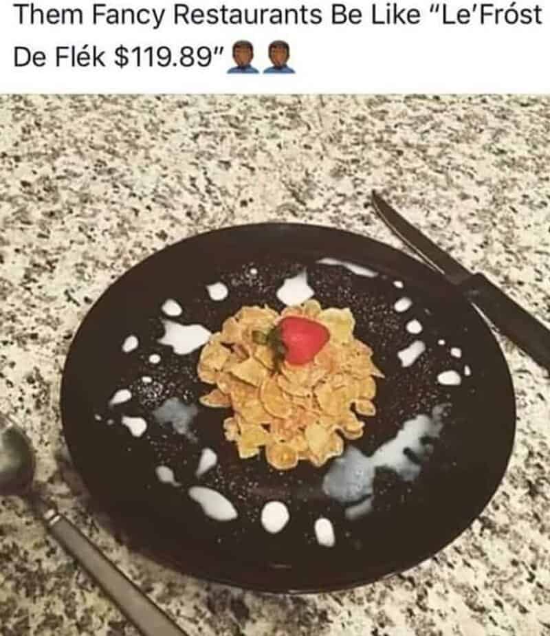 A black plate with cereal, a red heart-shaped item, and white milk splashes.