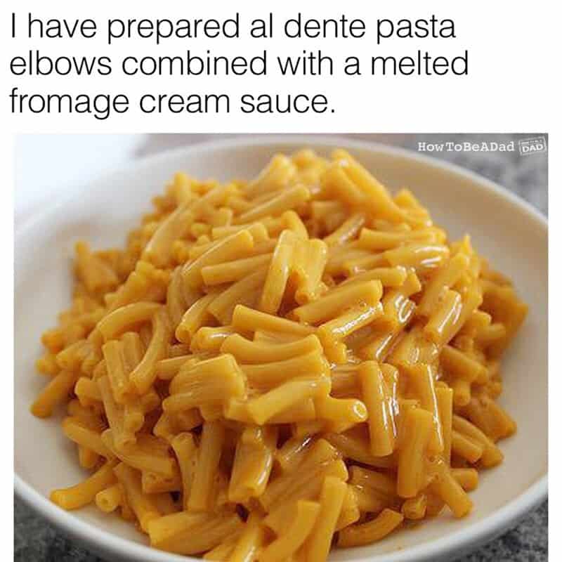 A bowl of pasta with melted cheese and cream sauce, resembling elbows.