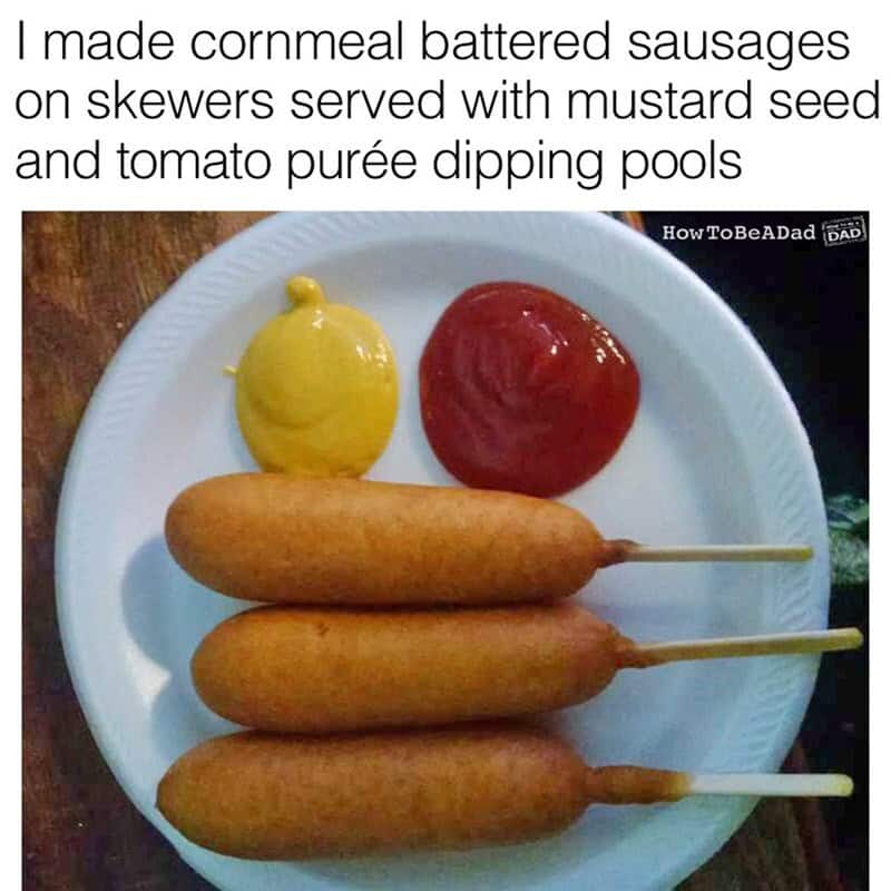 Cornmeal battered sausages on skewers with mustard seed and tomato purée dipping pools.
