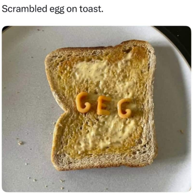 Scrambled egg on toast with cheese letters spelling 'GEC'.