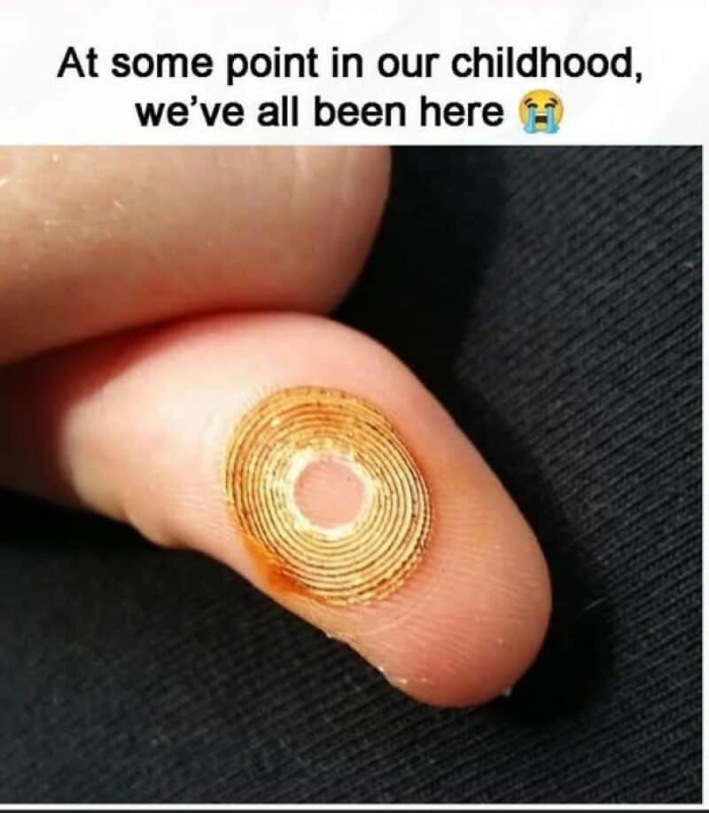 Close-up of a finger with a fingerprint pattern and a pinkish center.