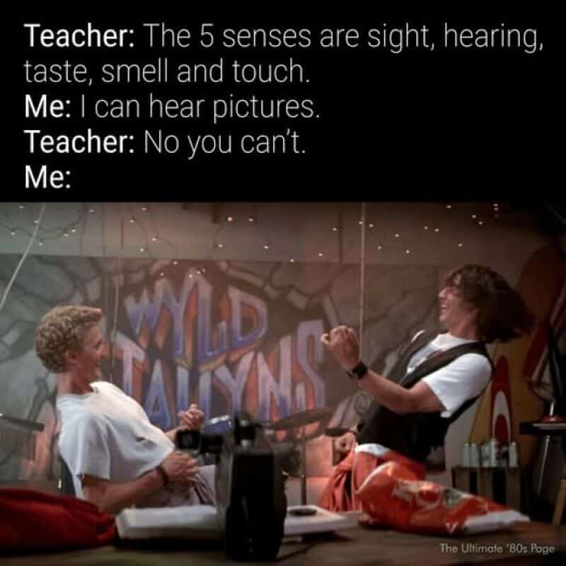 Teacher and student joking about the five senses in a classroom.