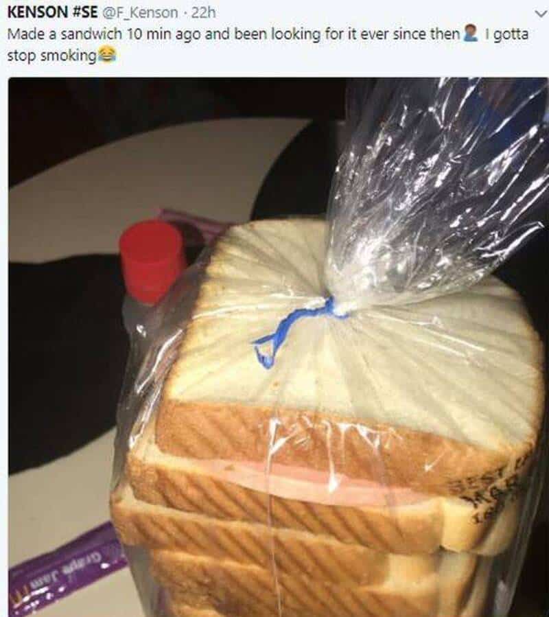 Sandwich made with sliced bread, sealed in a plastic bag, on a table.