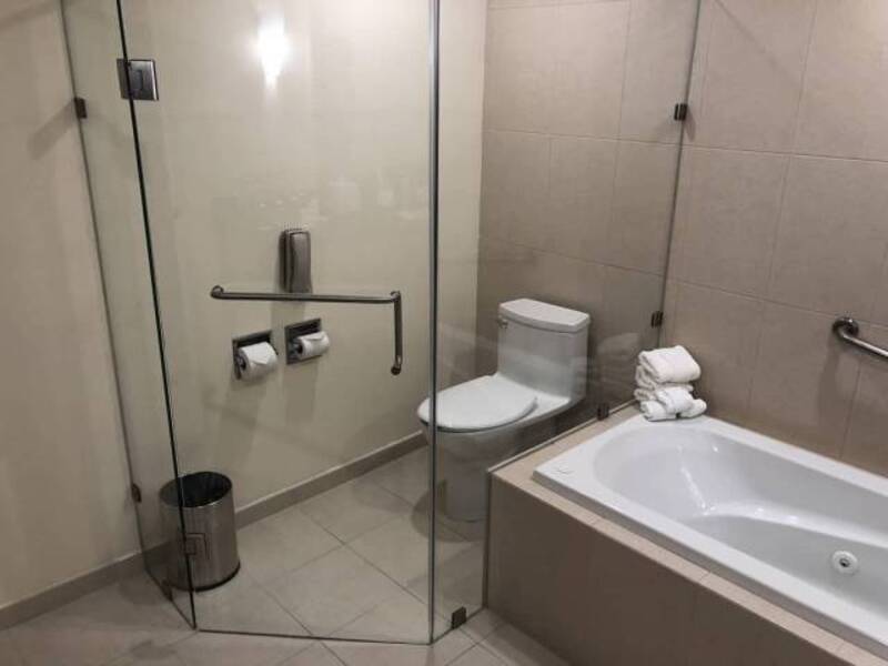 Bathroom with a toilet, bathtub, and glass shower enclosure.