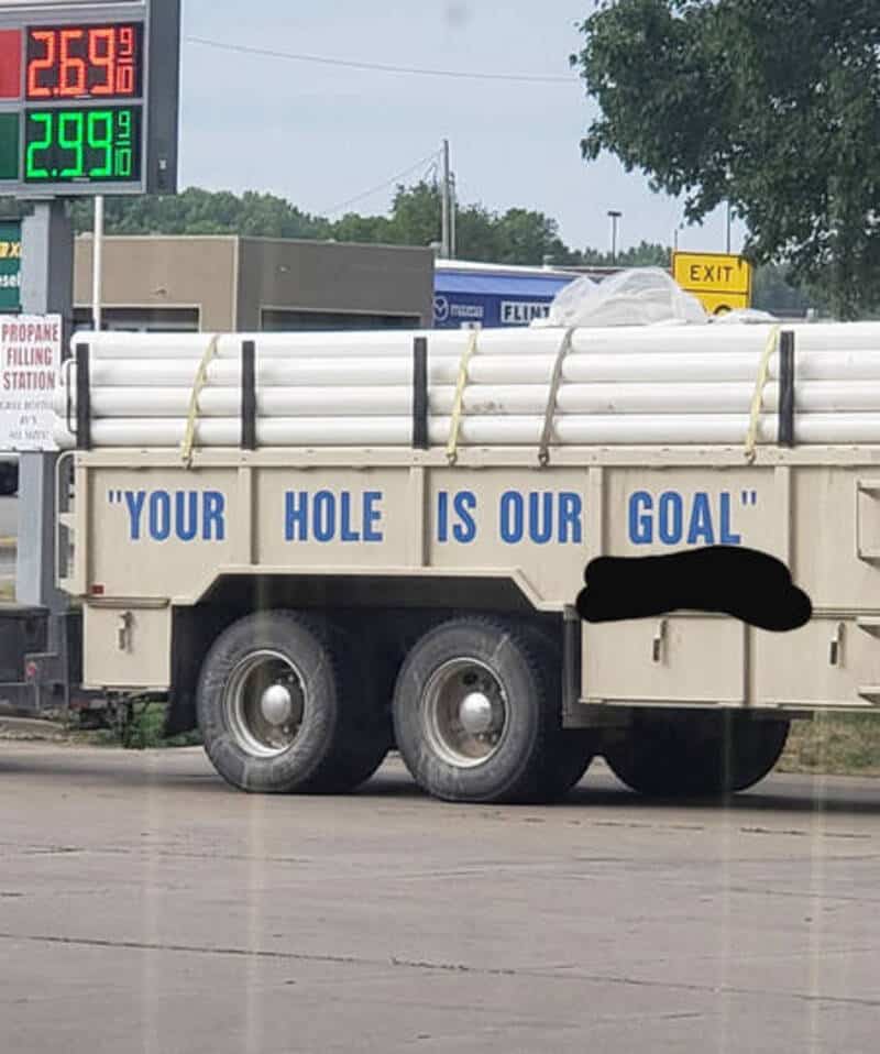 Truck with pipes and a sign saying "Your hole is our goal".