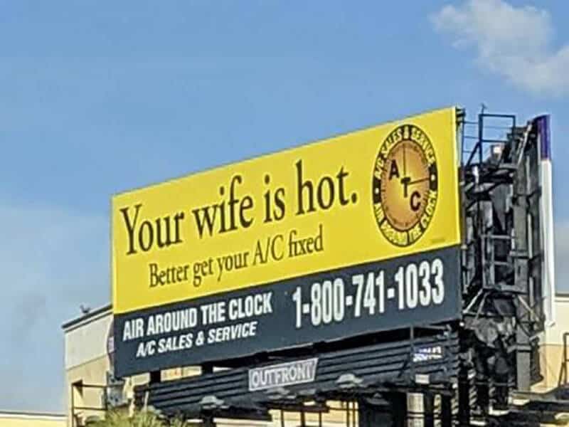 Billboard with humorous ad: 'Your wife is hot. Better get your A/C fixed.'.