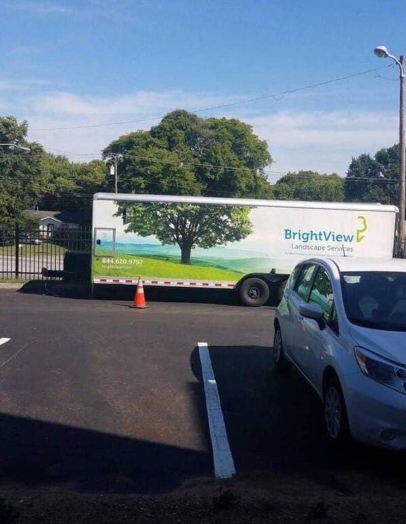 A truck with a tree image and the text 'BrightView Landscape Services' parked in a lot.