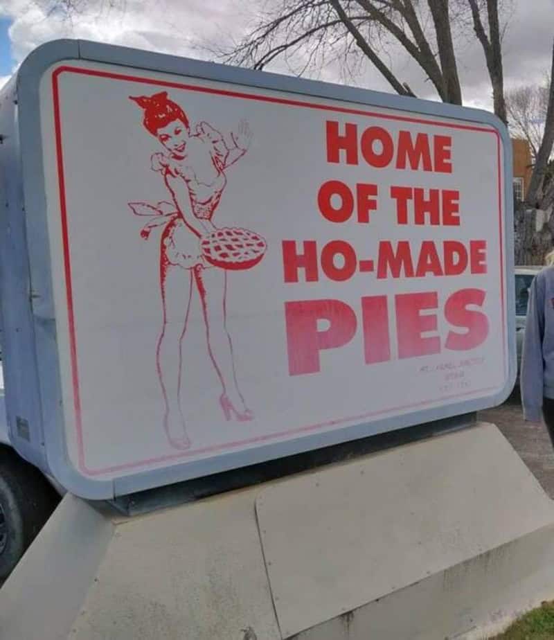 Sign reads 'Home of the Ho-Made Pies' with a drawing of a woman holding a pie.