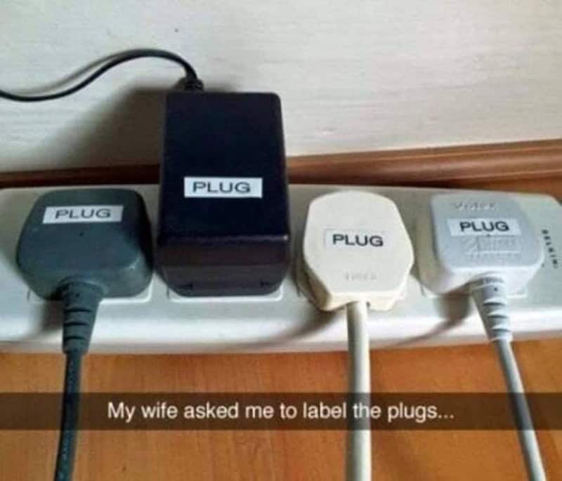 Four power plugs labeled 'PLUG' on a power strip with a caption about labeling plugs.