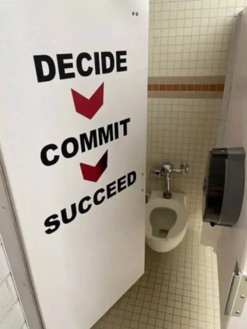 Decide, Commit, Succeed signs in a bathroom stall door.