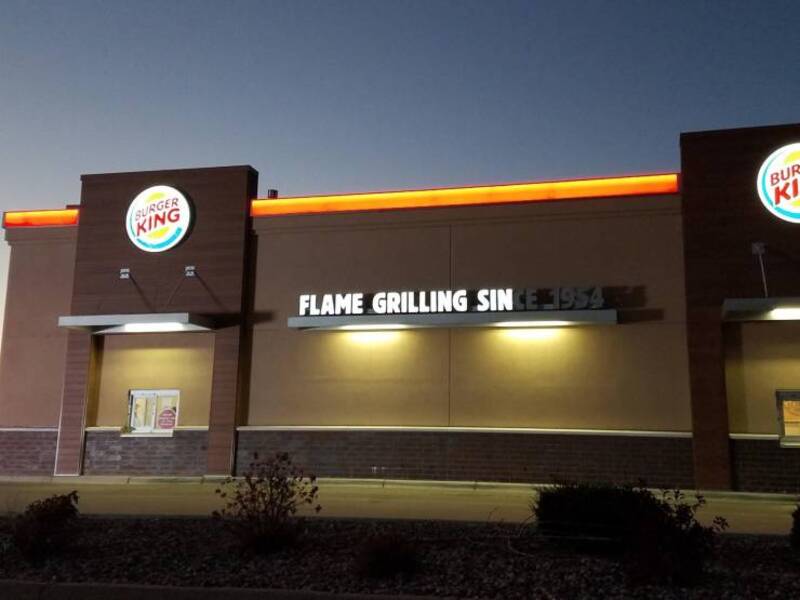 Burger King sign with a humorous misspelling of 'Flame Grilling Sin'.