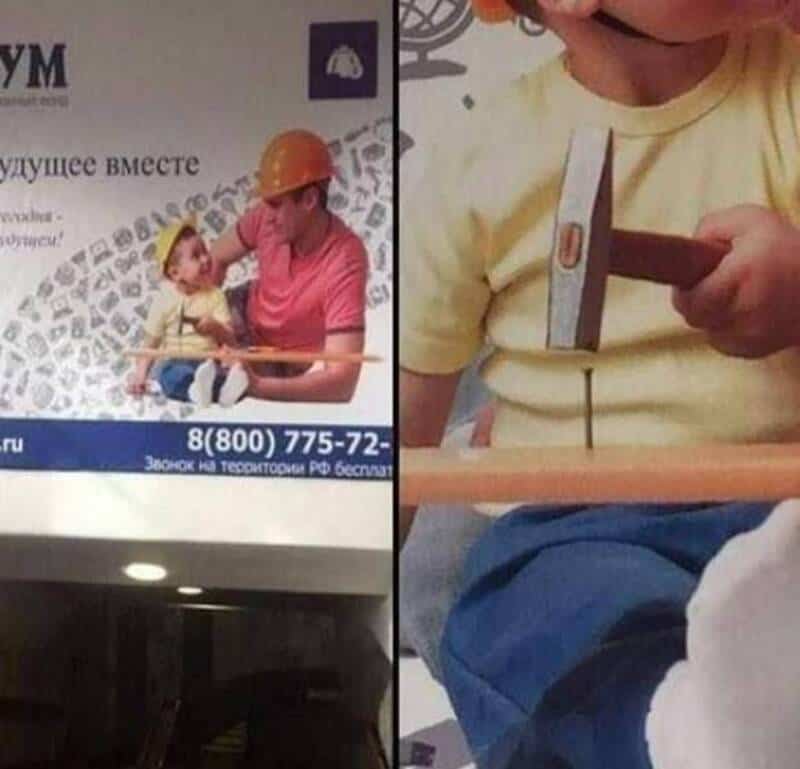 Child holding a hammer near a nail, with a woman wearing a construction helmet in the background.