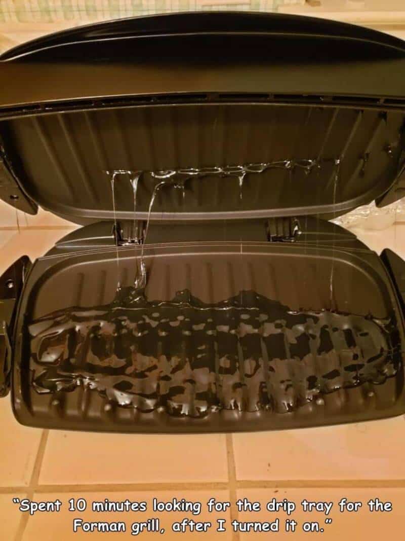 An open electric grill with water dripping inside, after being turned off.