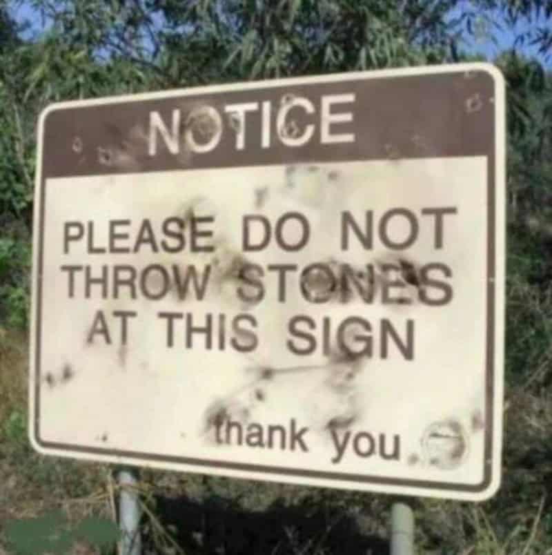 Notice sign says please do not throw stones at this sign.