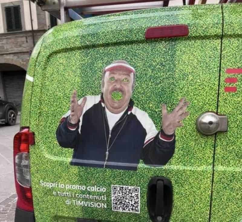 Man with a green ball in his mouth on a green van with promotional text.